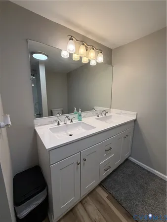 a bathroom with a double vanity sink and a mirror