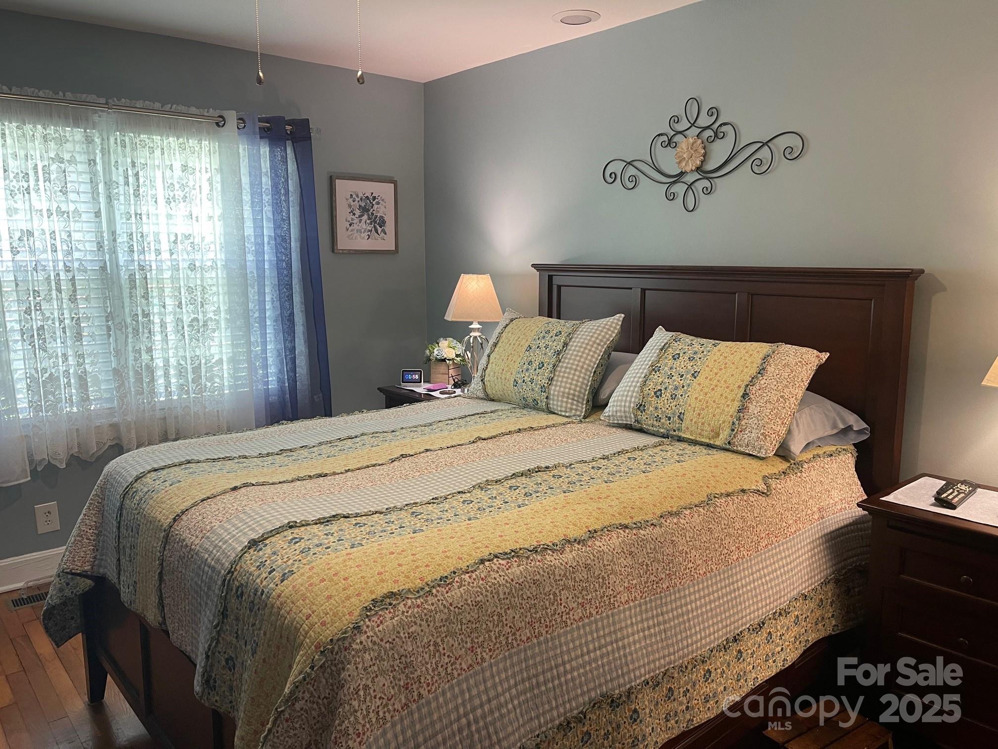 107 Calhoun Drive Cheraw, SC 29520 - Photo 11 of 16 a bedroom with a bed and a painting on the wall