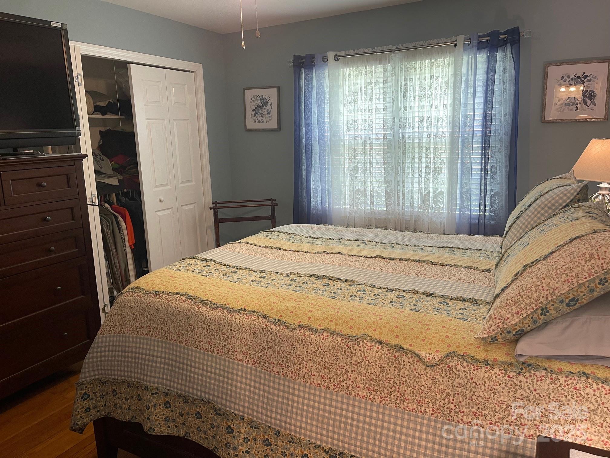 107 Calhoun Drive Cheraw, SC 29520 - Photo 12 of 16 a bedroom with a bed and a flat tv screen next to a window