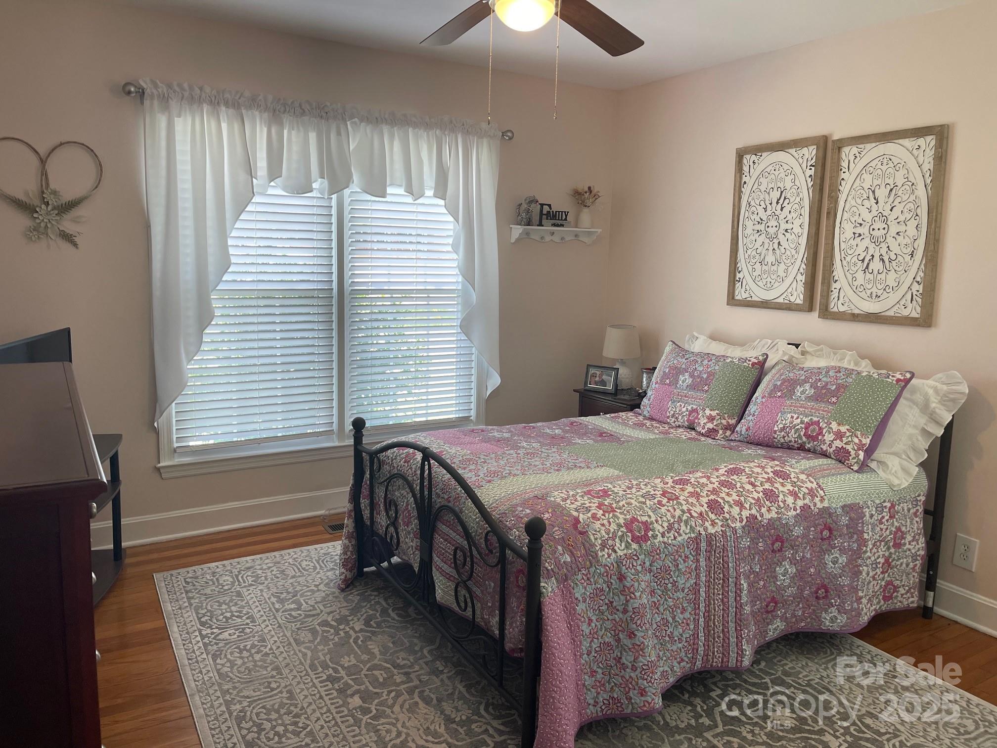 107 Calhoun Drive Cheraw, SC 29520 - Photo 15 of 16 a bedroom with a bed dresser and wooden floor