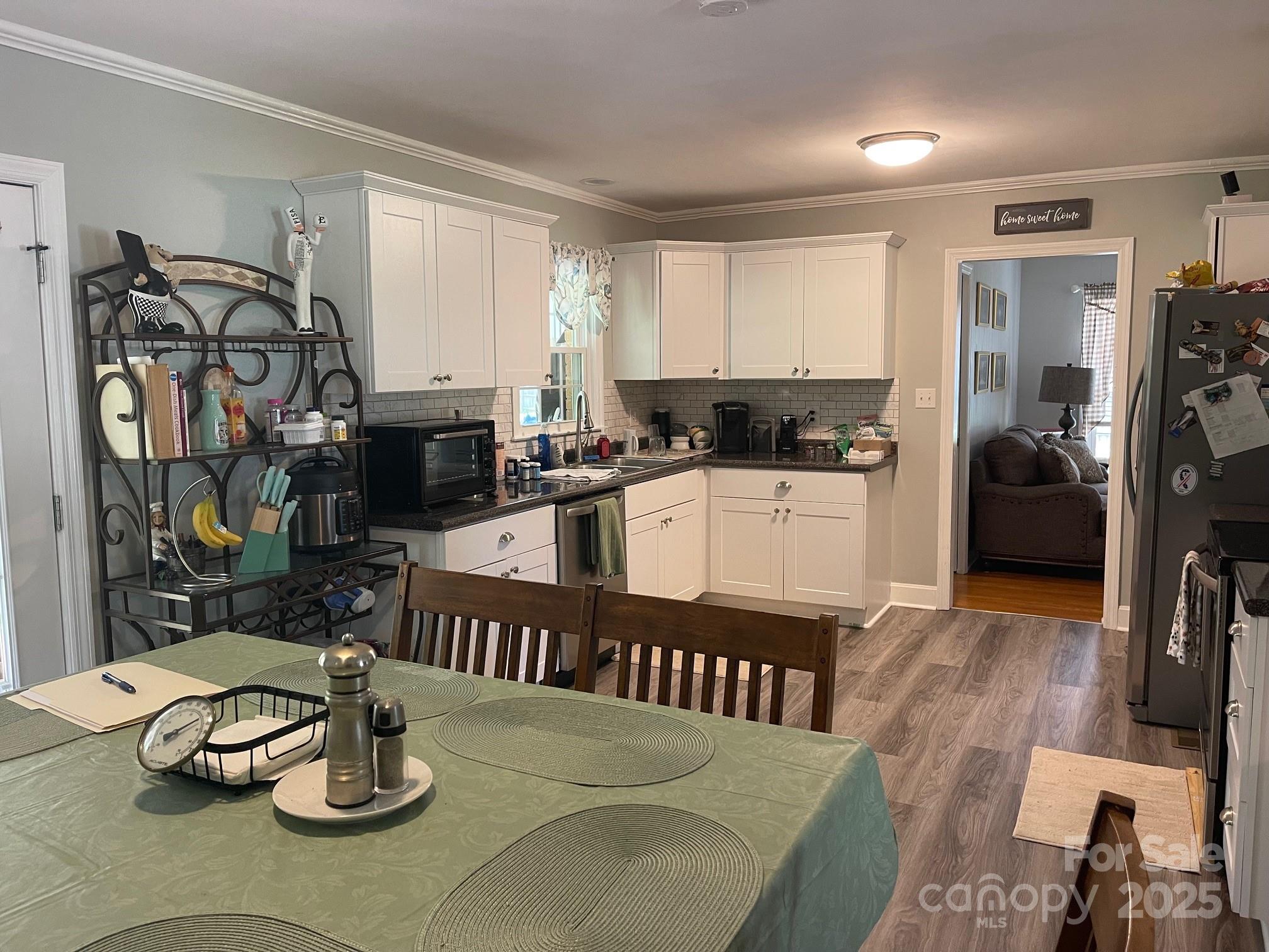 107 Calhoun Drive Cheraw, SC 29520 - Photo 7 of 16 a kitchen with stainless steel appliances kitchen island granite countertop a table chairs stove and cabinets