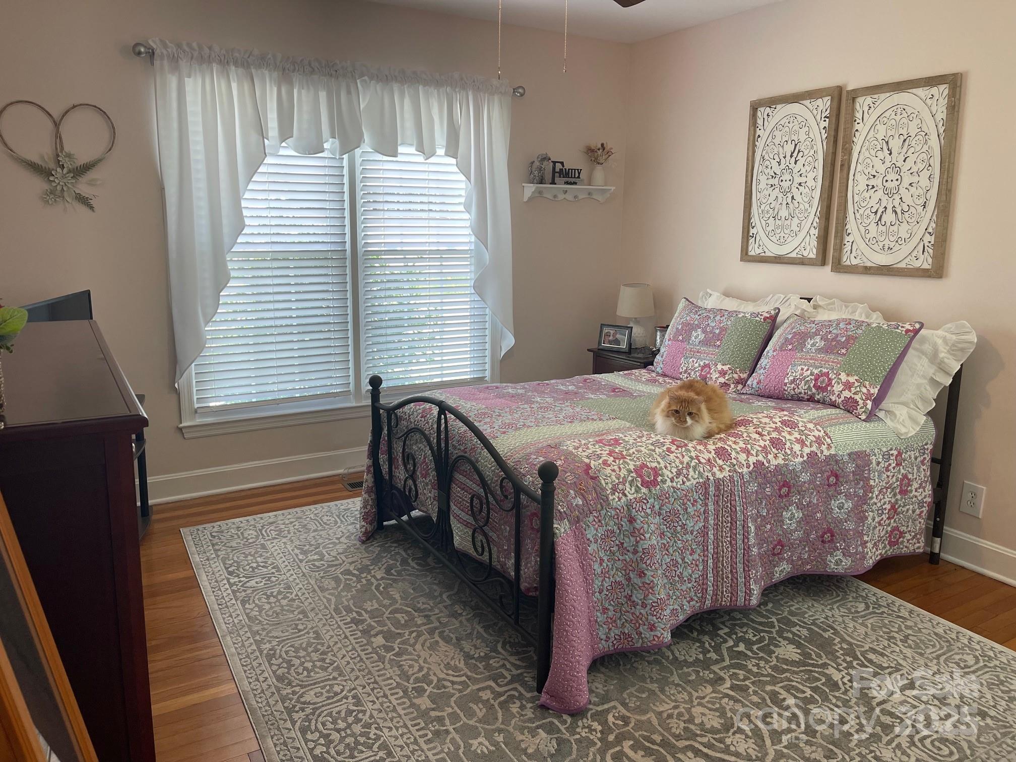107 Calhoun Drive Cheraw, SC 29520 - Photo 10 of 16 a bedroom with a bed and a dresser next to a window