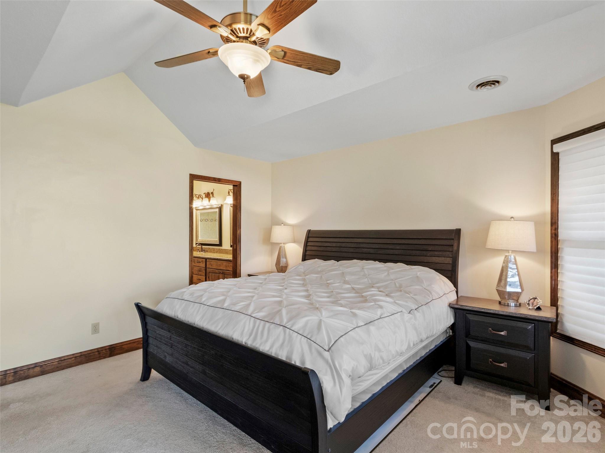 91 Brandy Run Road Burnsville, NC 28714 - Photo 16 of 45 a bedroom with a bed and a chandelier