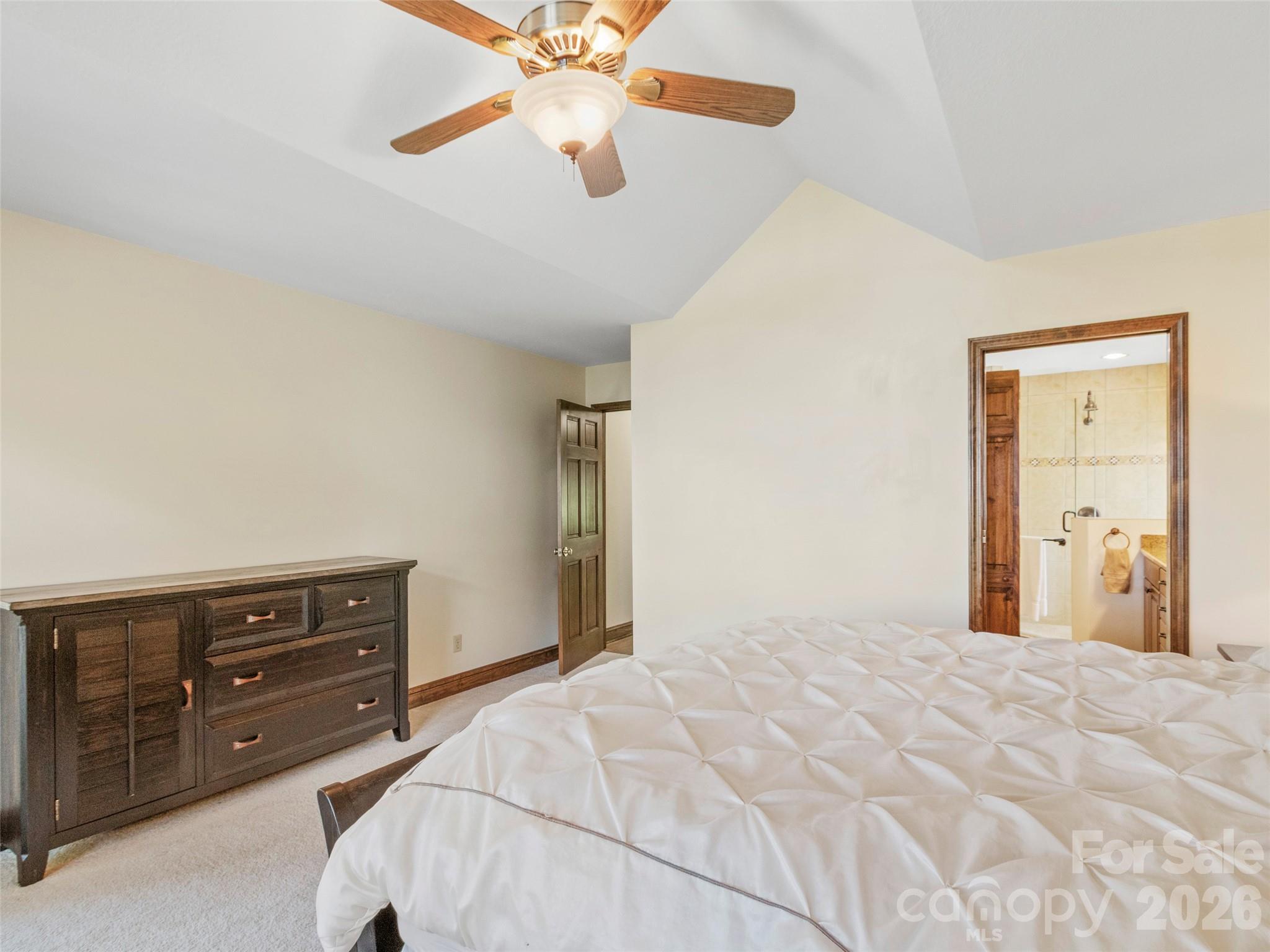 91 Brandy Run Road Burnsville, NC 28714 - Photo 17 of 45 a bedroom with a bed and a chandelier