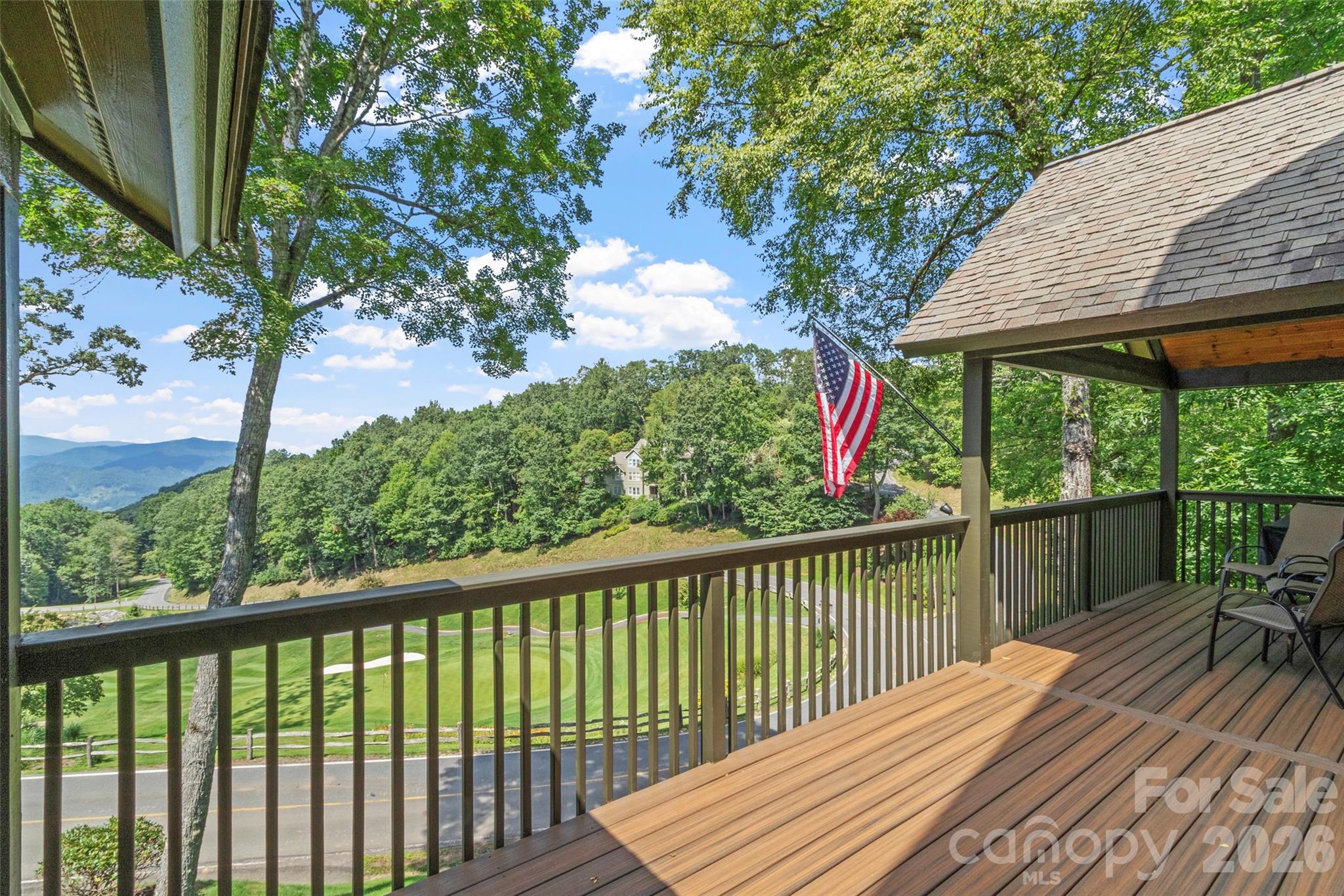 91 Brandy Run Road Burnsville, NC 28714 - Photo 2 of 45 a view of a wooden deck next to a yard