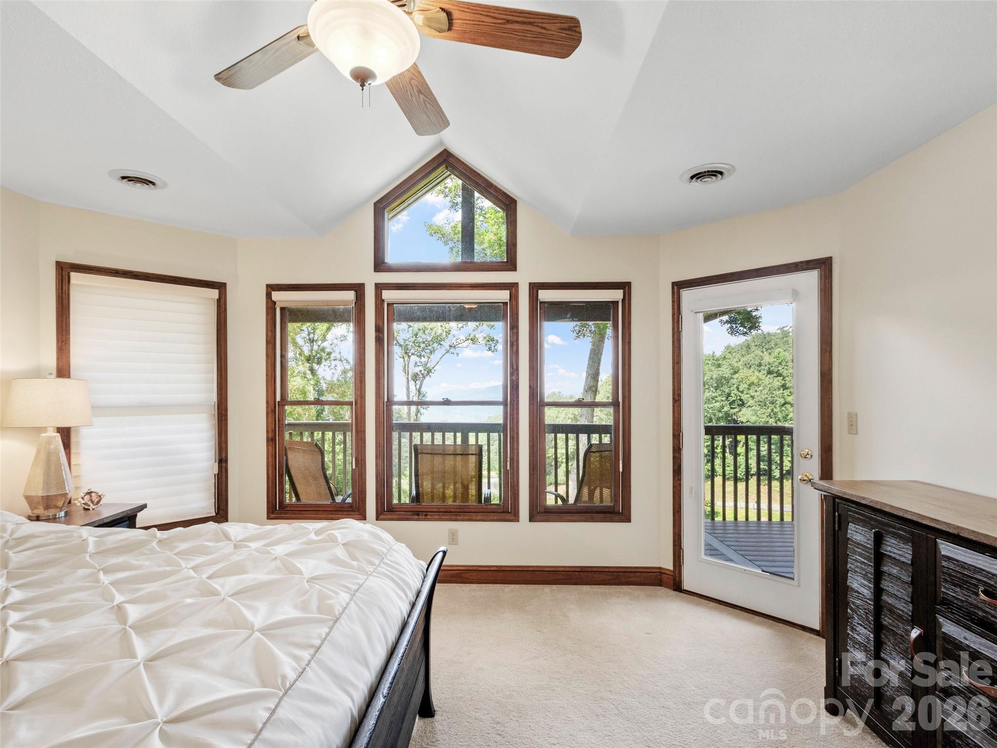91 Brandy Run Road Burnsville, NC 28714 - Photo 23 of 45 a spacious bedroom with a large bed and a large window