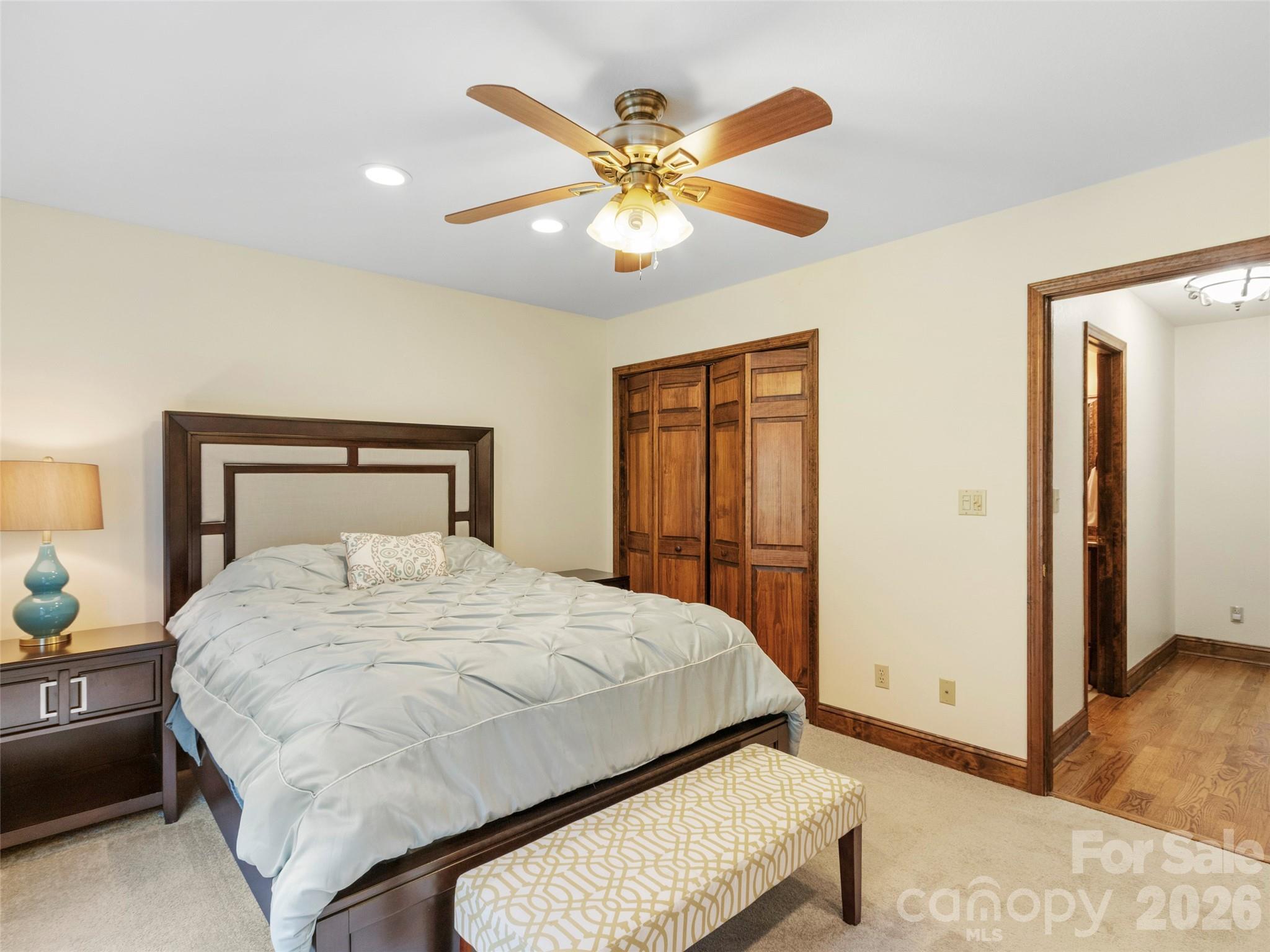91 Brandy Run Road Burnsville, NC 28714 - Photo 26 of 45 a bedroom with a bed and a chandelier