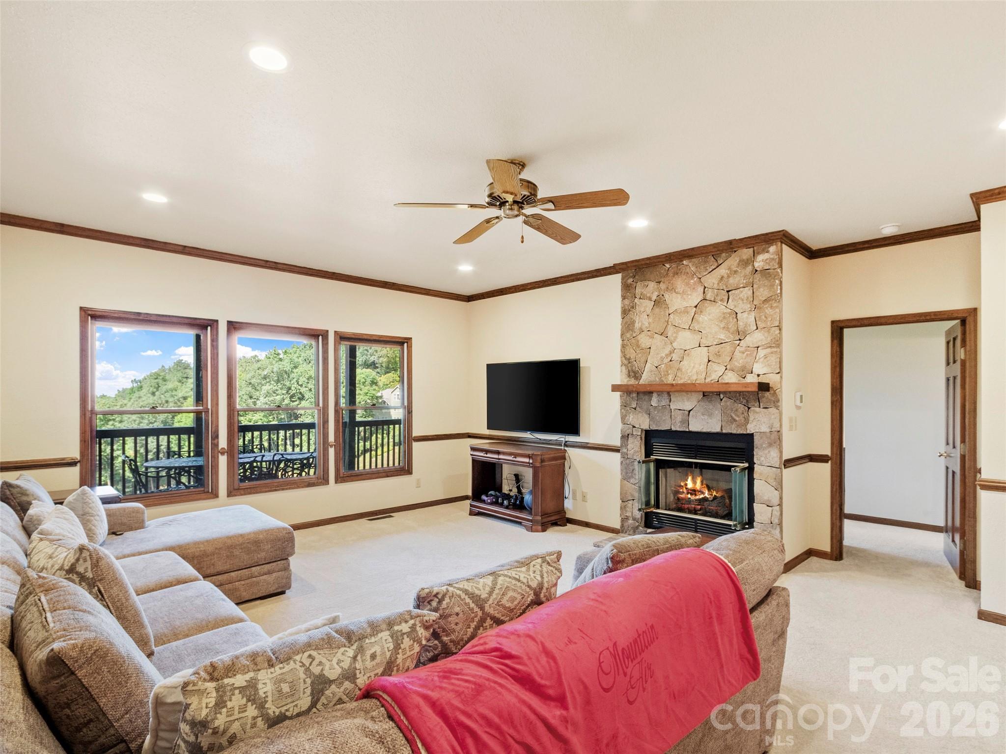 91 Brandy Run Road Burnsville, NC 28714 - Photo 28 of 45 a living room with furniture fireplace and a flat screen tv