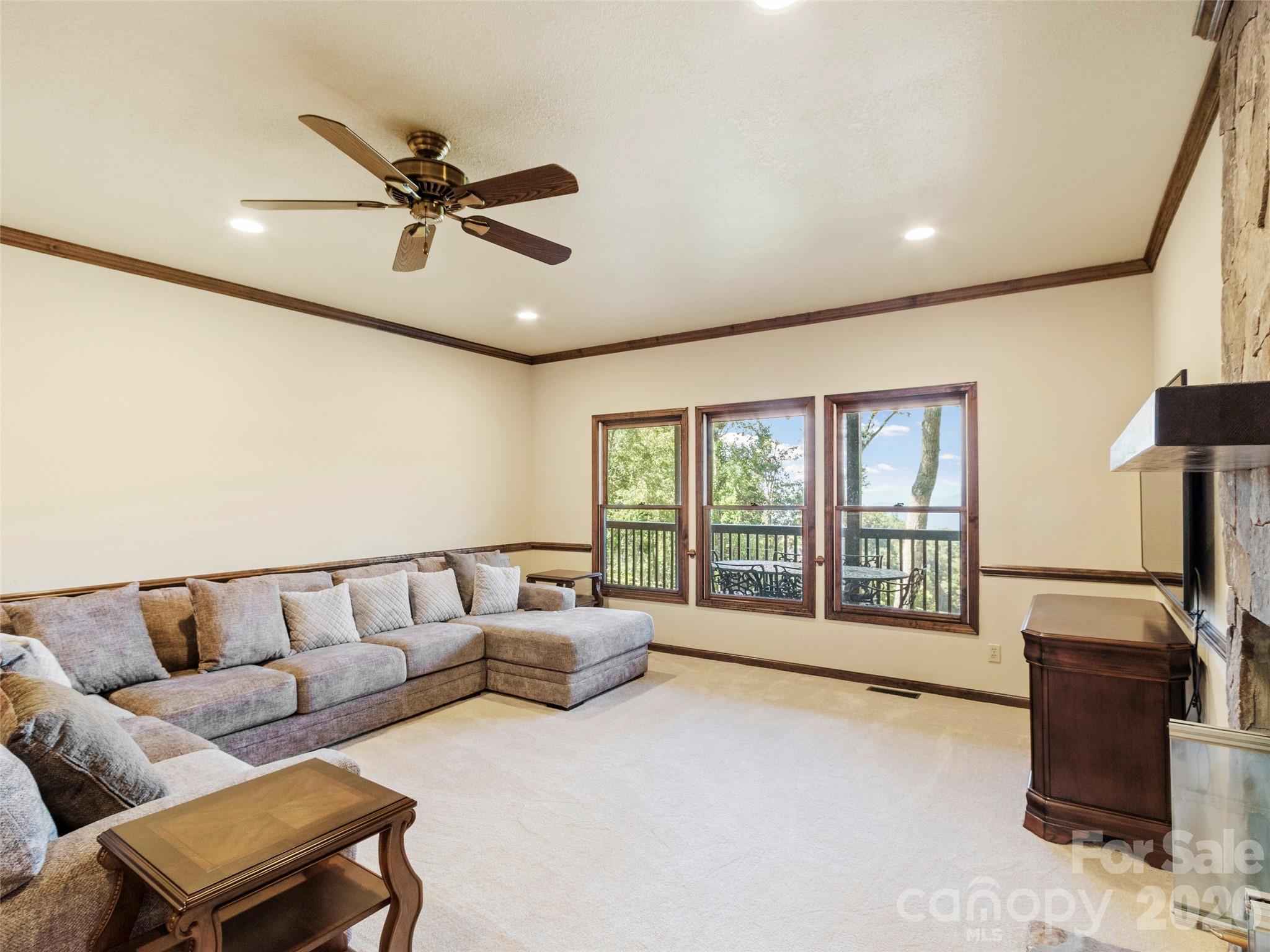 91 Brandy Run Road Burnsville, NC 28714 - Photo 29 of 45 a living room with furniture and a flat screen tv