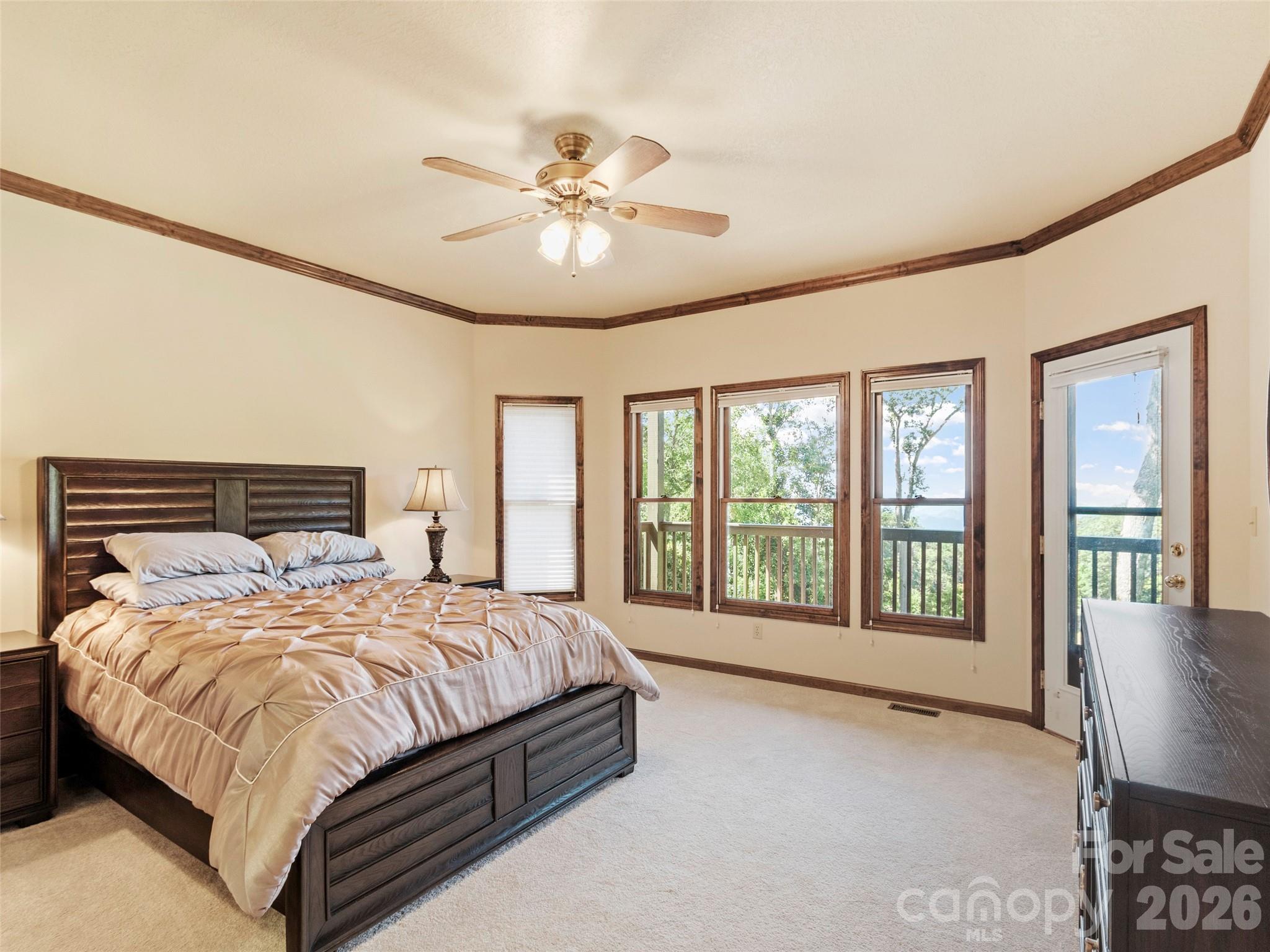 91 Brandy Run Road Burnsville, NC 28714 - Photo 33 of 45 a bedroom with a large bed and a large window