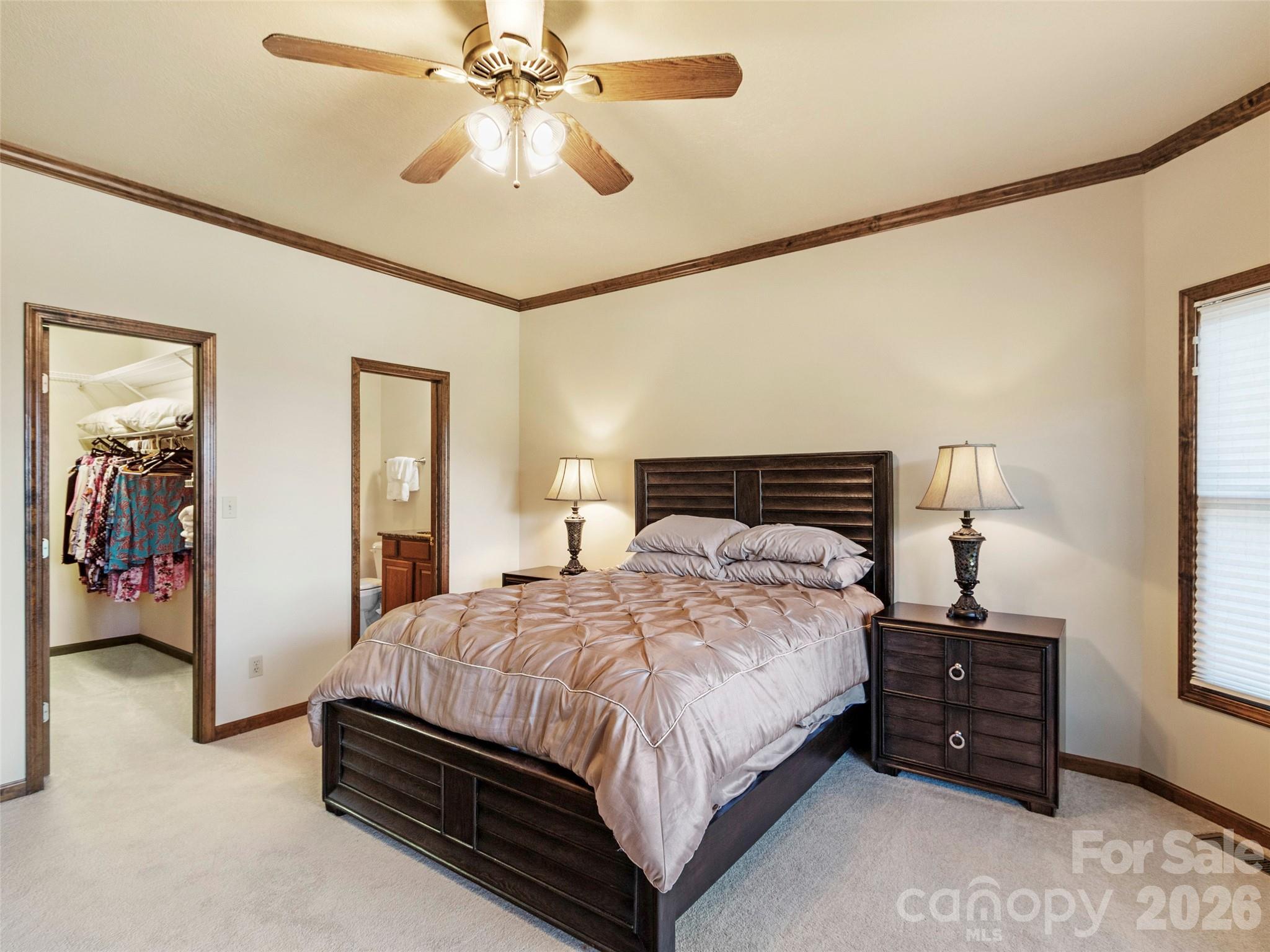 91 Brandy Run Road Burnsville, NC 28714 - Photo 34 of 45 a bedroom with a bed and a chandelier