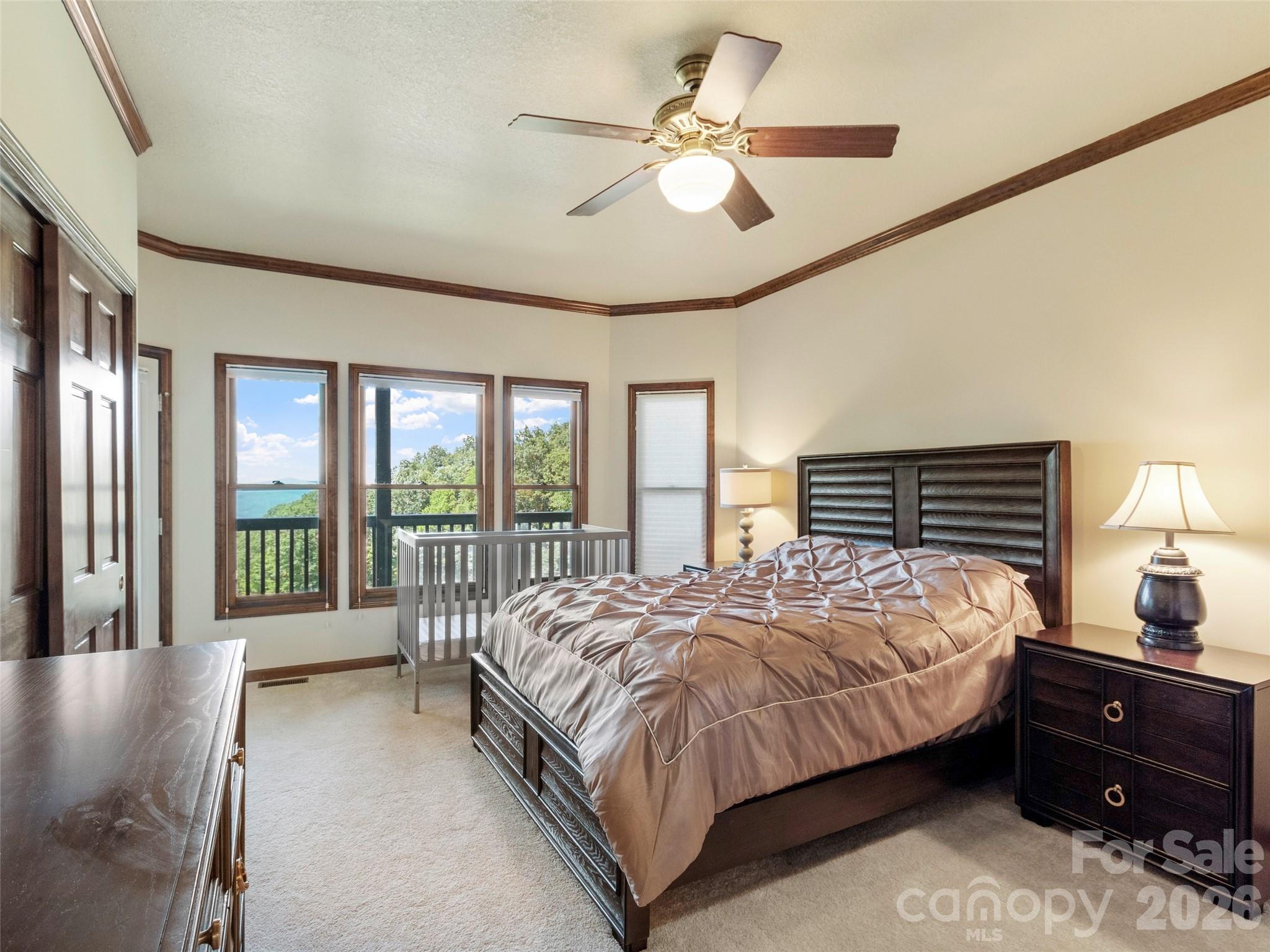 91 Brandy Run Road Burnsville, NC 28714 - Photo 41 of 45 a bedroom with a large bed and a large window