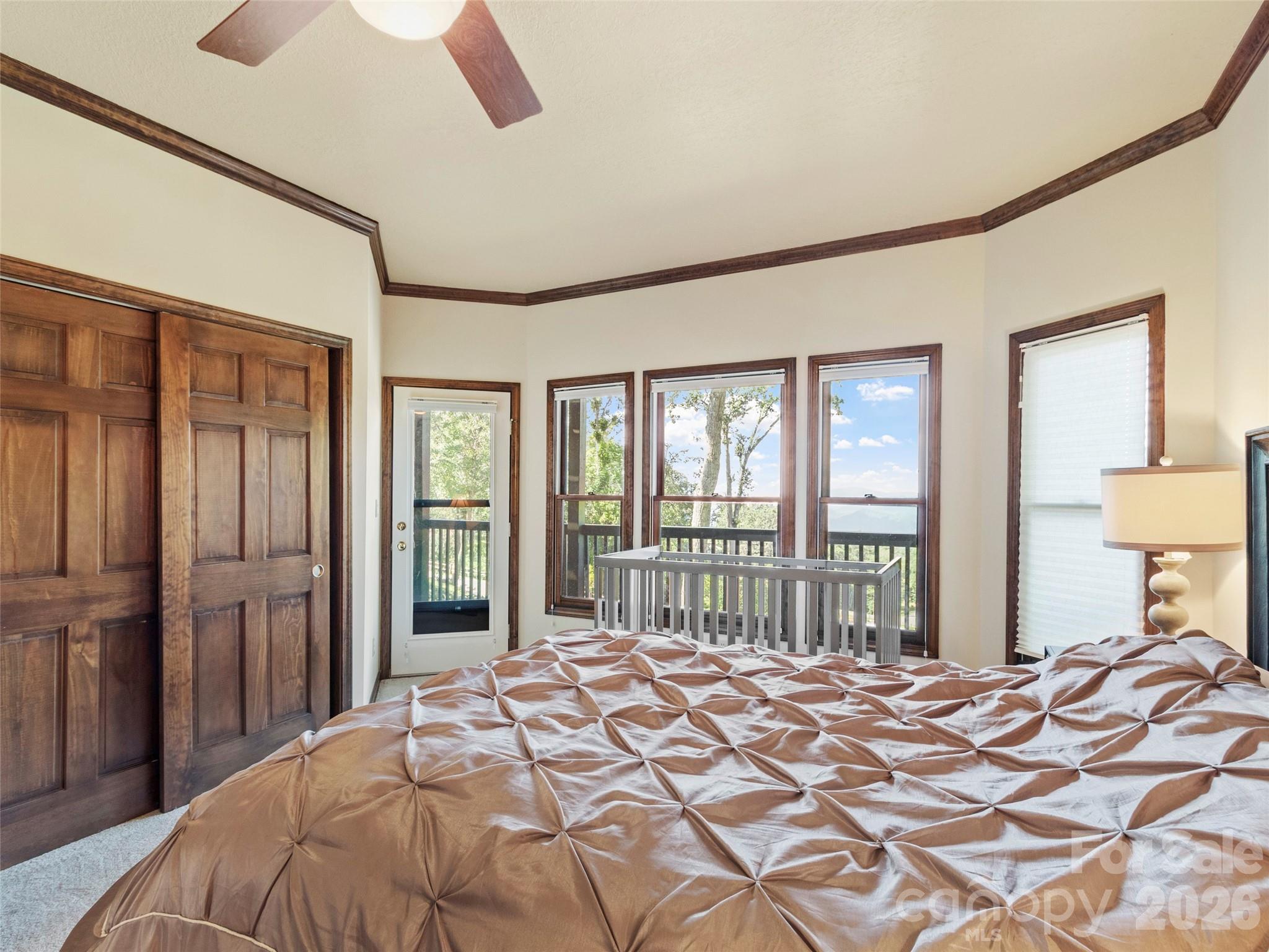 91 Brandy Run Road Burnsville, NC 28714 - Photo 42 of 45 a bedroom with a bed and a large window