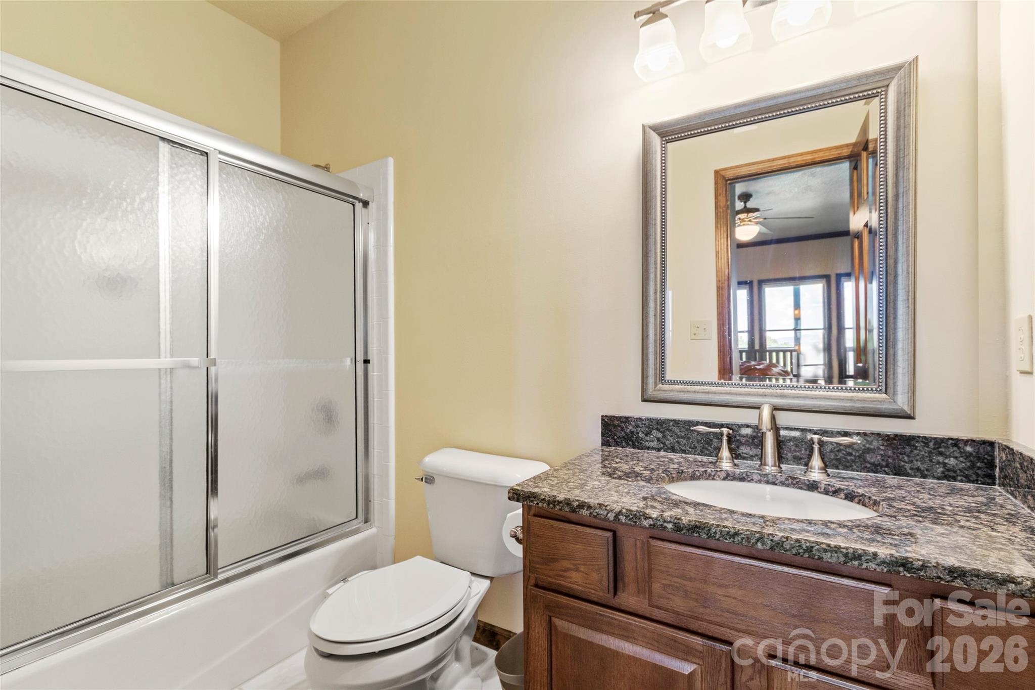 91 Brandy Run Road Burnsville, NC 28714 - Photo 43 of 45 a bathroom with a granite countertop sink toilet and shower