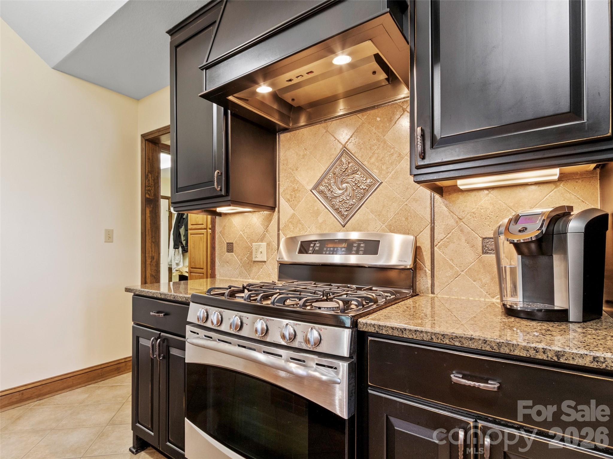 91 Brandy Run Road Burnsville, NC 28714 - Photo 10 of 45 a kitchen with granite countertop a stove and a microwave