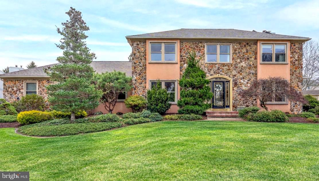 9 Timber Wolf Drive Hamilton, NJ 08620 - Photo 1 of 48 a front view of a house with a yard and potted plants