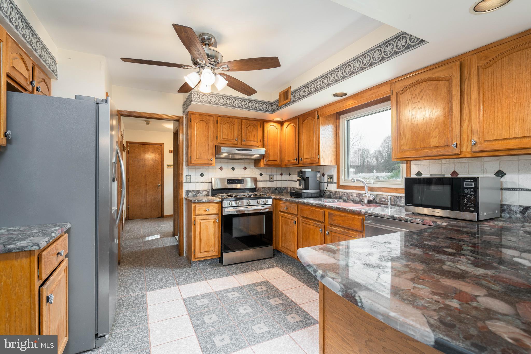 9 Timber Wolf Drive Hamilton, NJ 08620 - Photo 12 of 48 a large kitchen with stainless steel appliances granite countertop a stove refrigerator and a sink