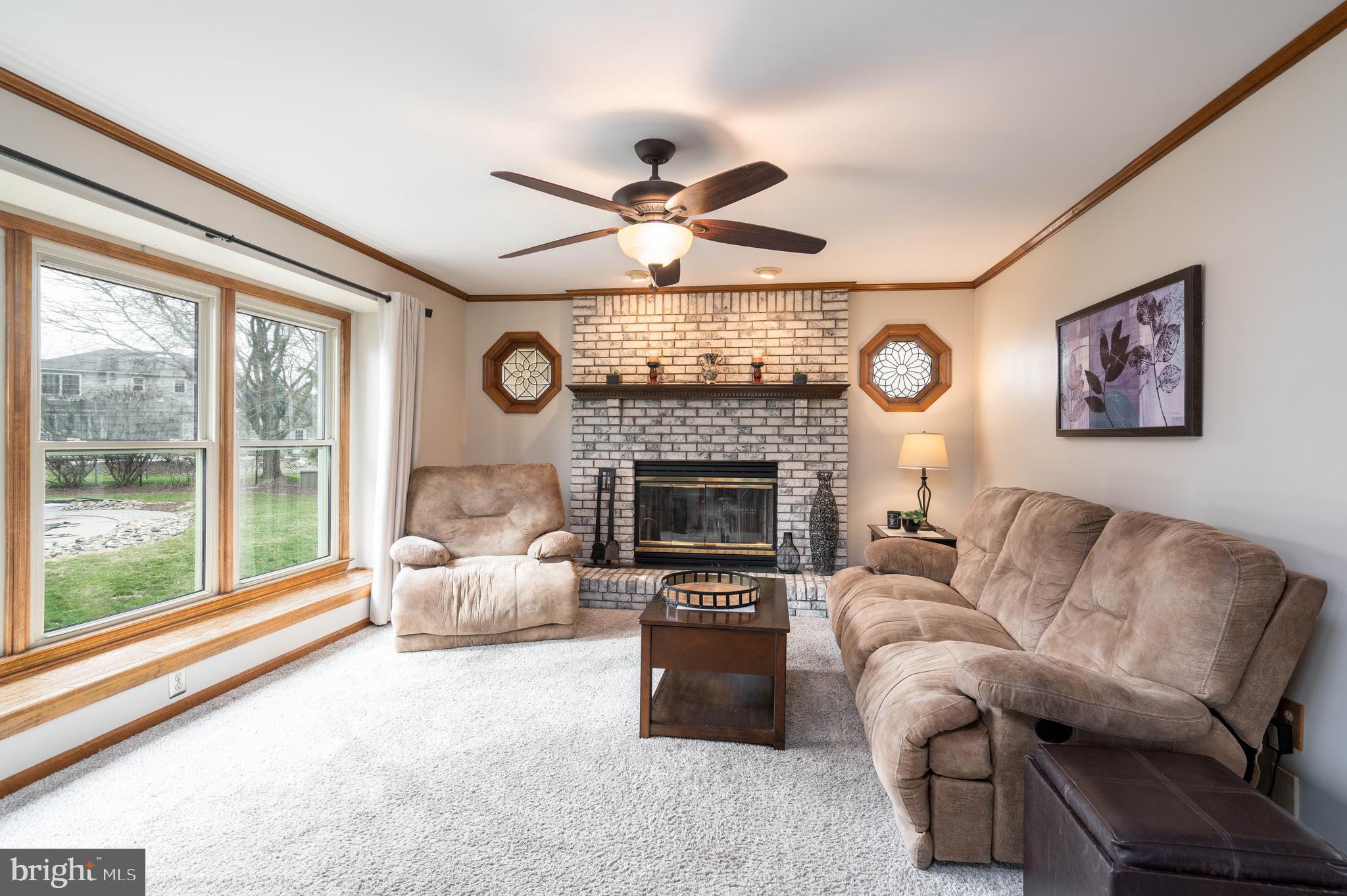9 Timber Wolf Drive Hamilton, NJ 08620 - Photo 16 of 48 a living room with furniture a fireplace and a large window