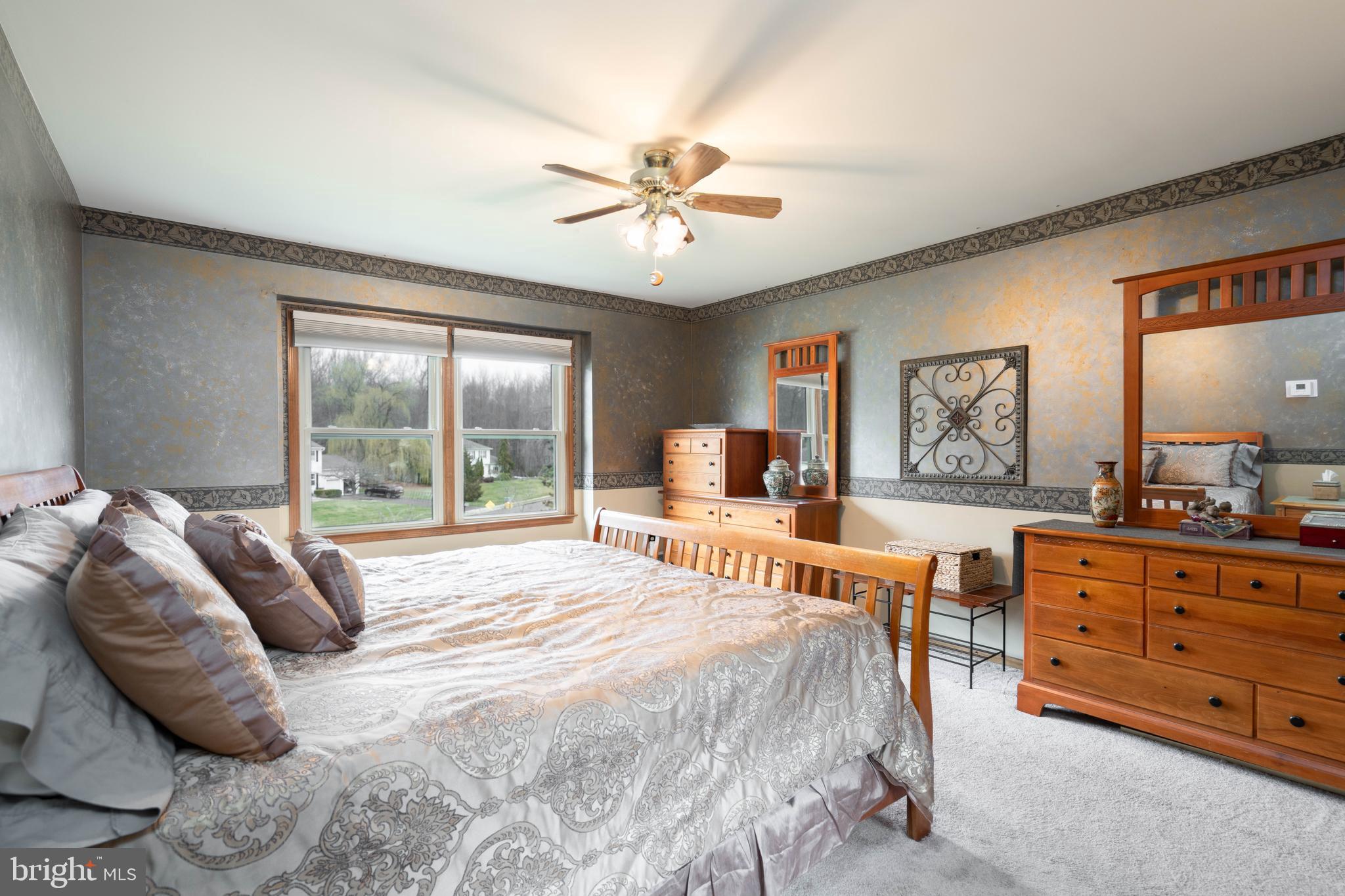 9 Timber Wolf Drive Hamilton, NJ 08620 - Photo 28 of 48 a spacious bedroom with a large bed and a chandelier