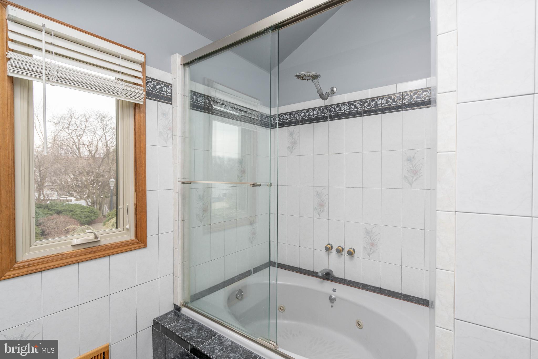 9 Timber Wolf Drive Hamilton, NJ 08620 - Photo 31 of 48 a bathroom with a tub and a shower