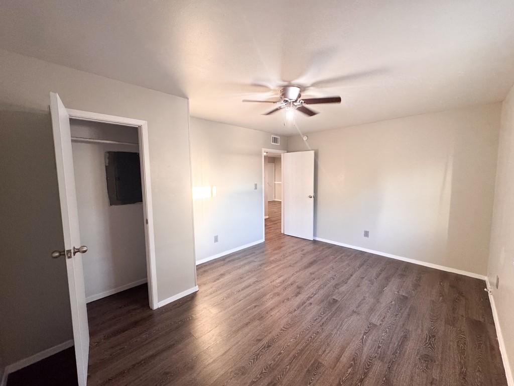 1050 Farm To Market Road 970, Unit B Florence, TX 76527 - Photo 11 of 26 an empty room with wooden floor and ceiling fan