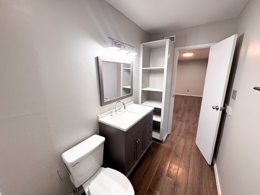 1050 Farm To Market Road 970, Unit B Florence, TX 76527 - Photo 13 of 26 a bathroom with a toilet sink and mirror