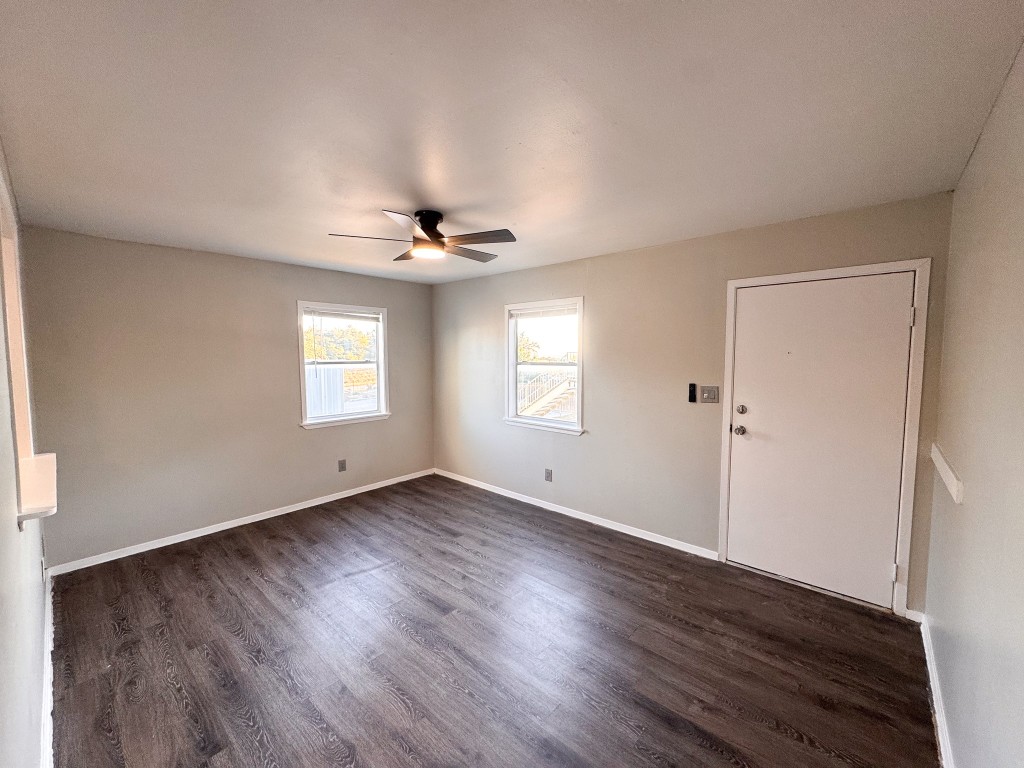 1050 Farm To Market Road 970, Unit B Florence, TX 76527 - Photo 2 of 26 a view of an empty room with wooden floor and a window