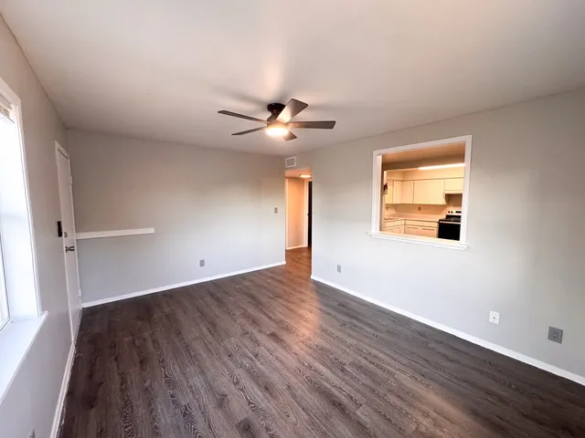 wooden floor in an empty room with a window