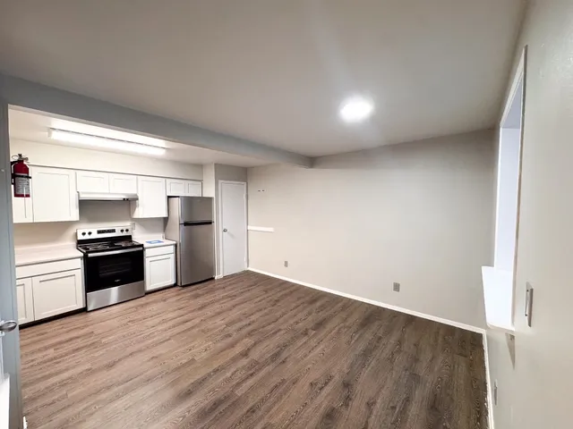 a kitchen with stainless steel appliances a refrigerator and a stove