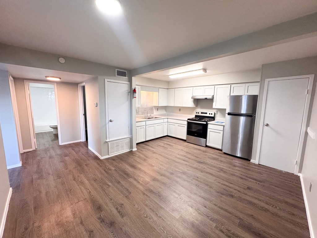 1050 Farm To Market Road 970, Unit B Florence, TX 76527 - Photo 6 of 26 a kitchen with stainless steel appliances granite countertop a refrigerator and a stove top oven