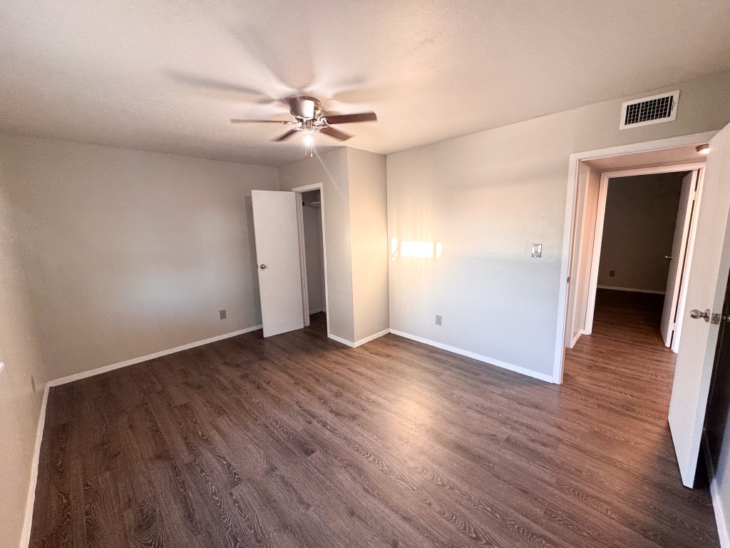 1050 Farm To Market Road 970, Unit B Florence, TX 76527 - Photo 10 of 26 an empty room with wooden floor and ceiling fan