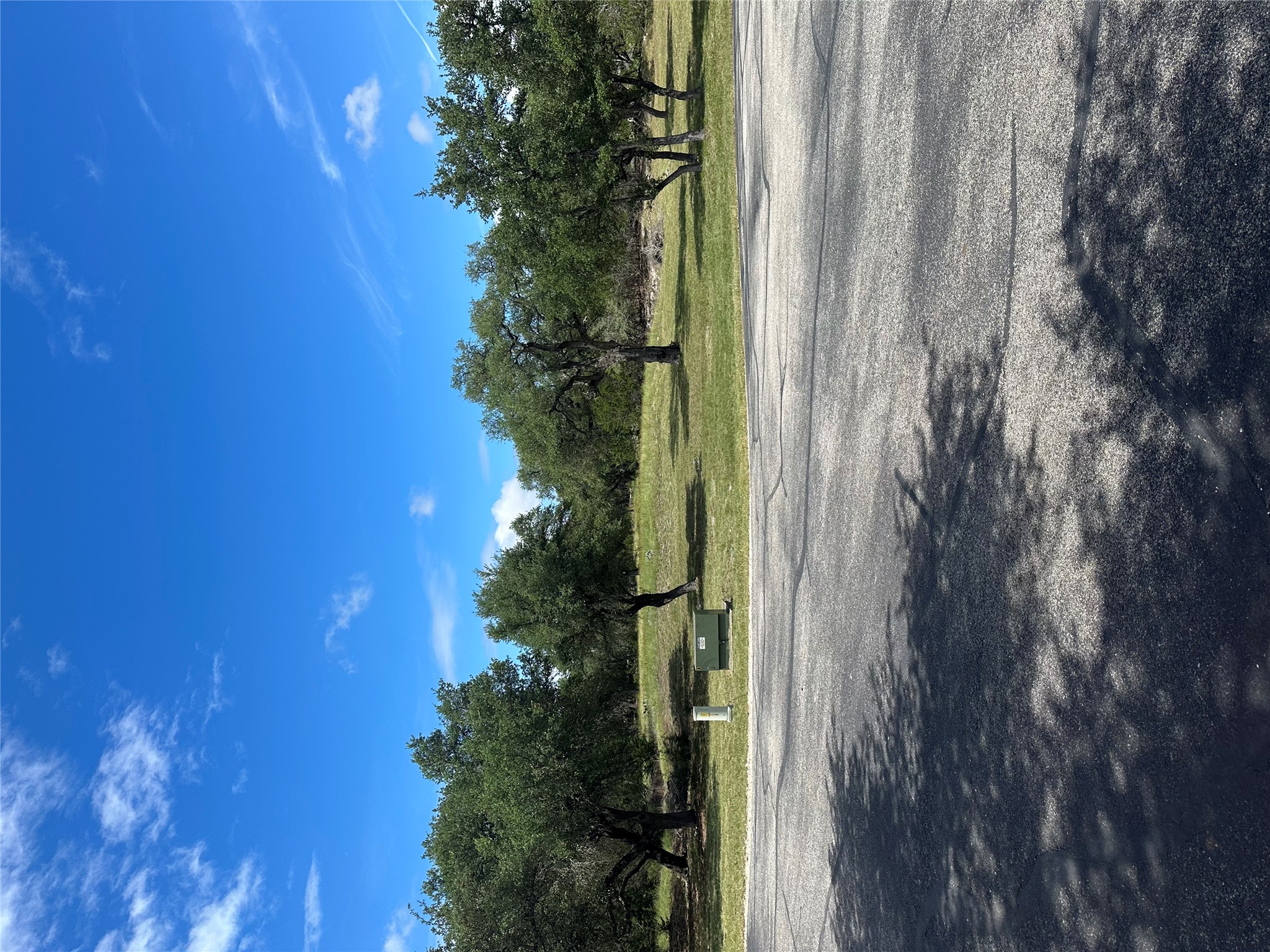 0 Lantana Gold Spring Branch, TX 78070 - Photo 3 of 15 Green landscape with mature trees and a clear, blue sky offers a serene setting for a future home.