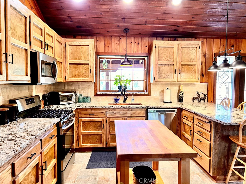 29555 Wyle Ranch Road North Fork, CA 93643 - Photo 11 of 70 a kitchen with stainless steel appliances granite countertop a stove a sink and a microwave