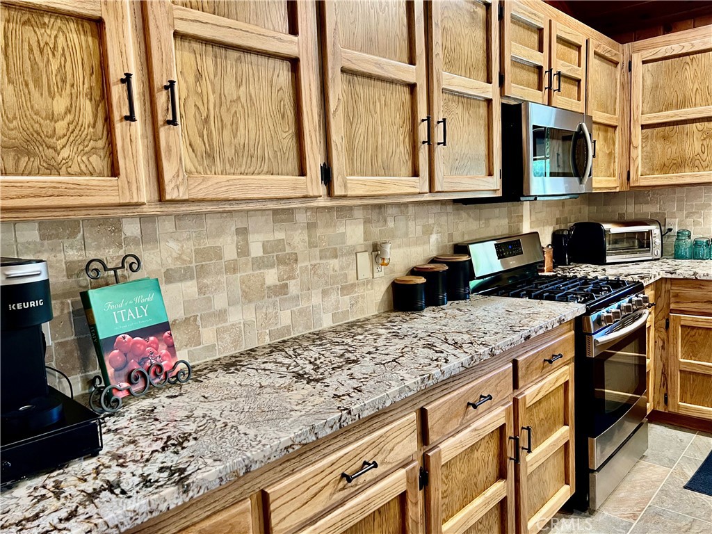 29555 Wyle Ranch Road North Fork, CA 93643 - Photo 12 of 70 a kitchen with stainless steel appliances granite countertop a stove and a sink