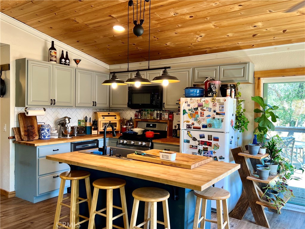 29555 Wyle Ranch Road North Fork, CA 93643 - Photo 46 of 70 a kitchen with stainless steel appliances granite countertop a sink a stove and a refrigerator