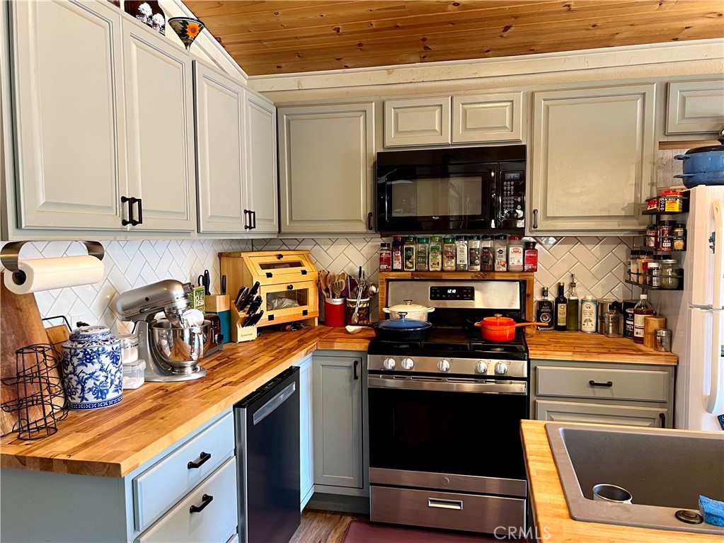 29555 Wyle Ranch Road North Fork, CA 93643 - Photo 47 of 70 a kitchen with stainless steel appliances a stove a sink and a microwave