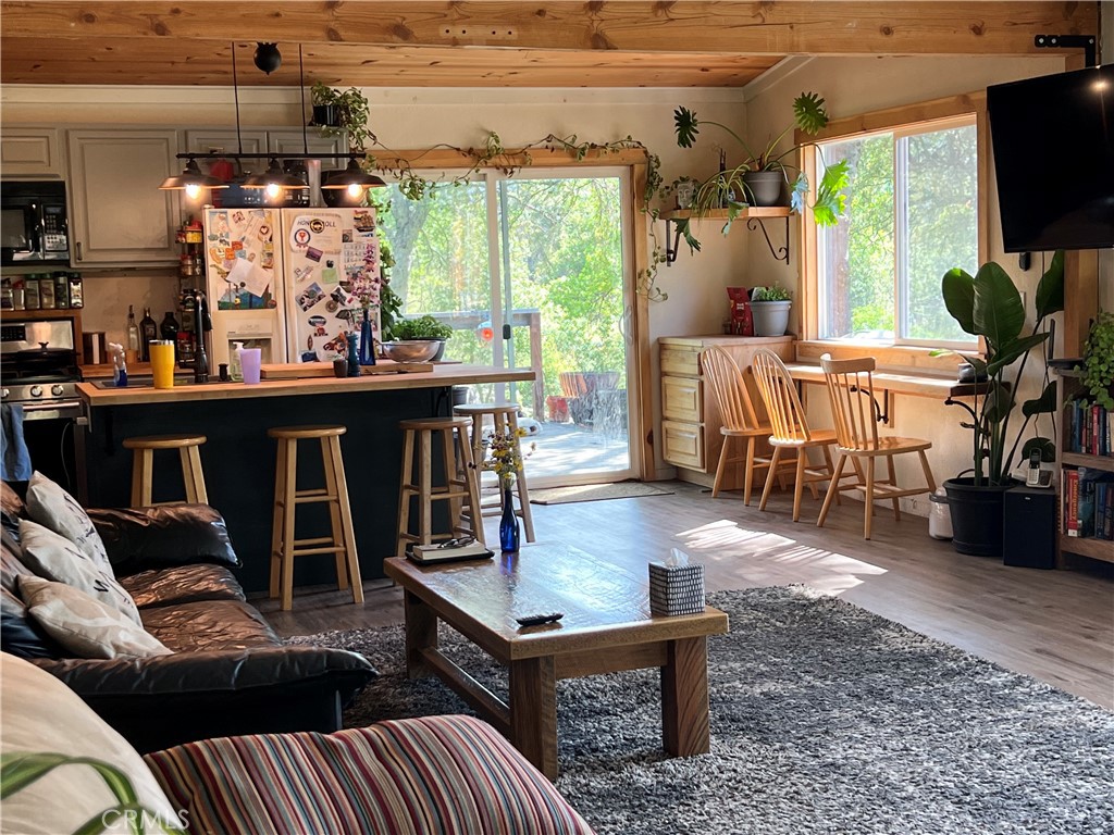 29555 Wyle Ranch Road North Fork, CA 93643 - Photo 51 of 70 a living room with furniture a flat screen tv and a floor to ceiling window