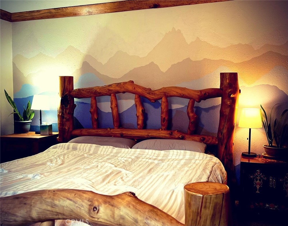 29555 Wyle Ranch Road North Fork, CA 93643 - Photo 55 of 70 a bed sitting in a bedroom next to a lamp