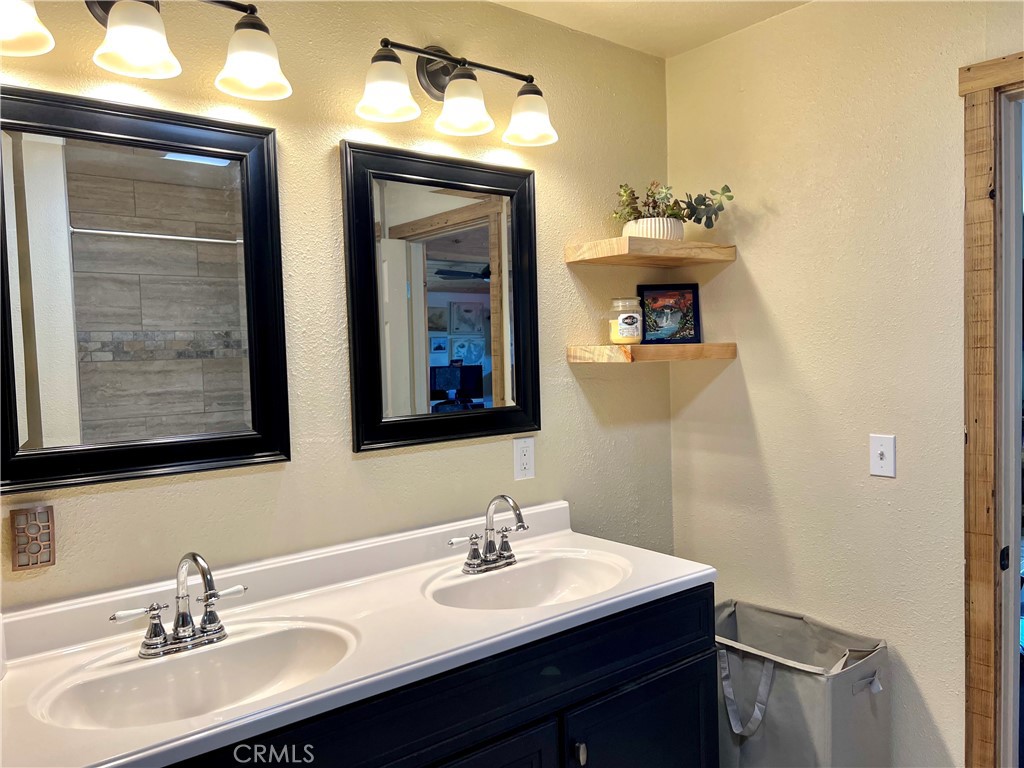 29555 Wyle Ranch Road North Fork, CA 93643 - Photo 56 of 70 a bathroom with a sink and a mirror