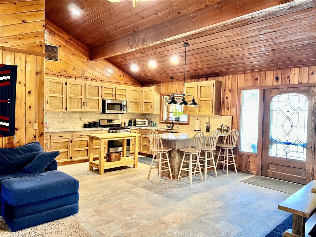 29555 Wyle Ranch Road North Fork, CA 93643 - Photo 9 of 70 a living room with stainless steel appliances kitchen island granite countertop a table chairs and a view of living room