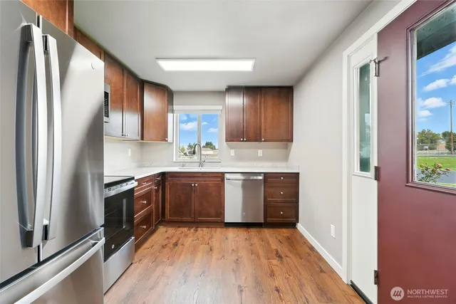a kitchen with stainless steel appliances granite countertop a refrigerator sink and cabinets