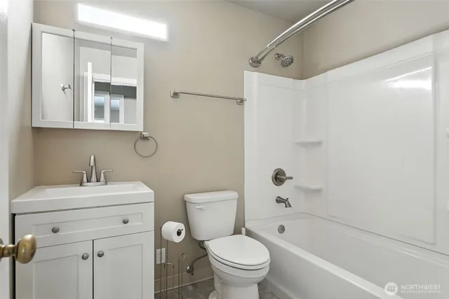 a bathroom with a sink toilet vanity and shower