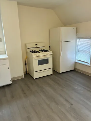 a view of a kitchen with a stove top oven
