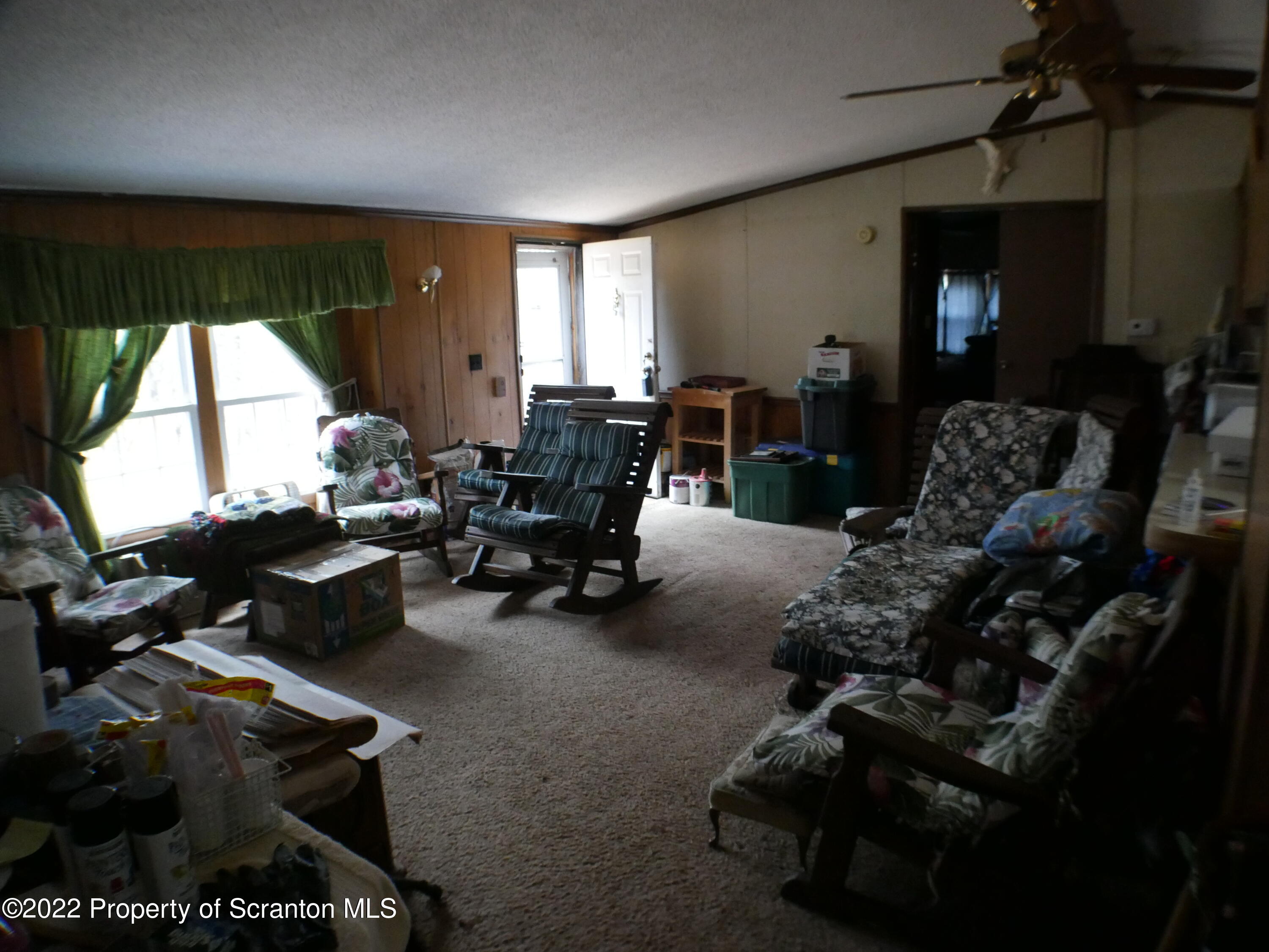 991 Bennett Road Hop Bottom, PA 18824 - Photo 5 of 36 a living room with furniture a window and gym equipment