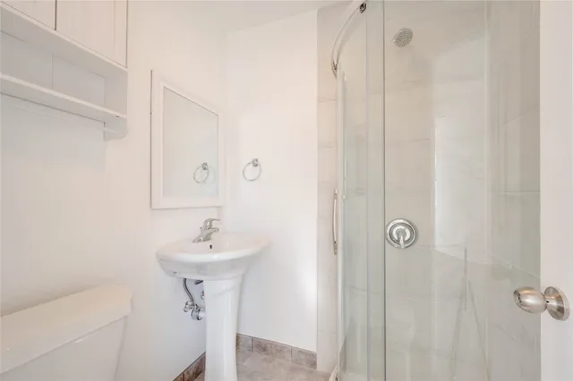 a bathroom with a sink a mirror and shower