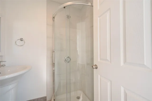 a bathroom with a shower and a sink