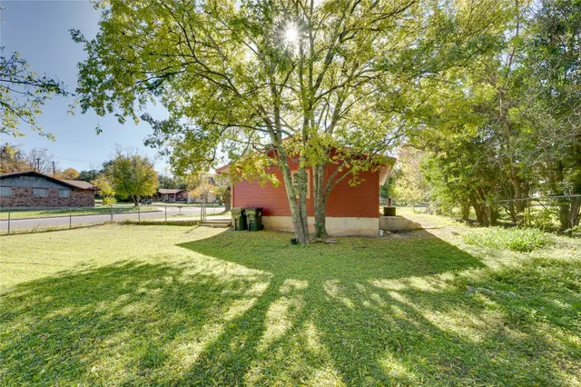 a view of backyard with swimming pool