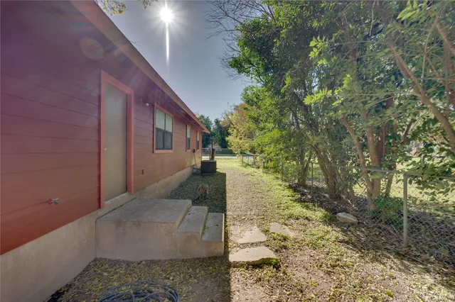 a view of a pathway of a house with a yard