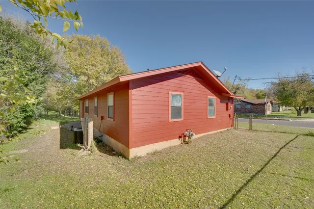 a backyard of a house with table and chairs