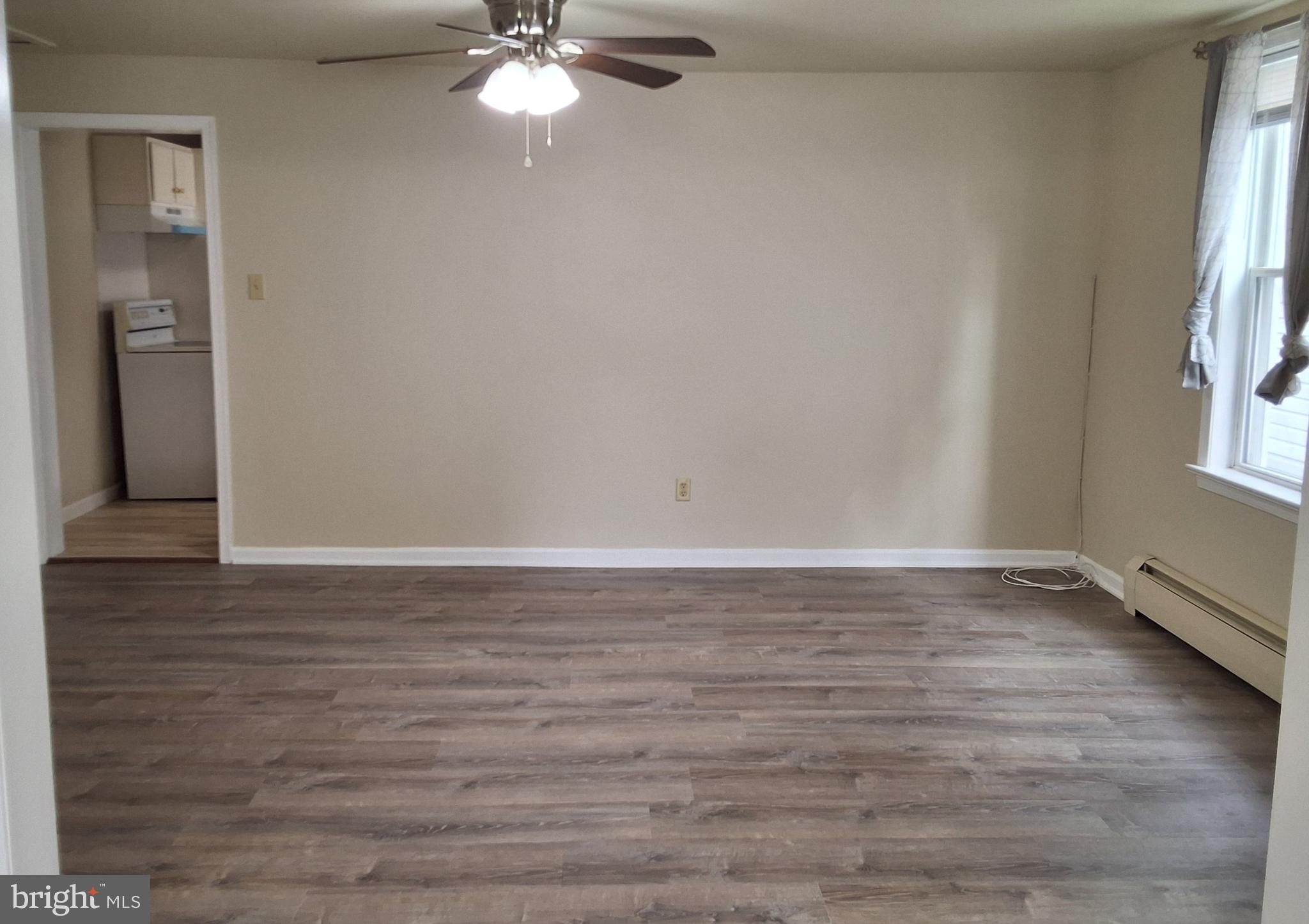59 West Slokom Avenue Christiana, PA 17509 - Photo 6 of 28 a view of an empty room with wooden floor and a window